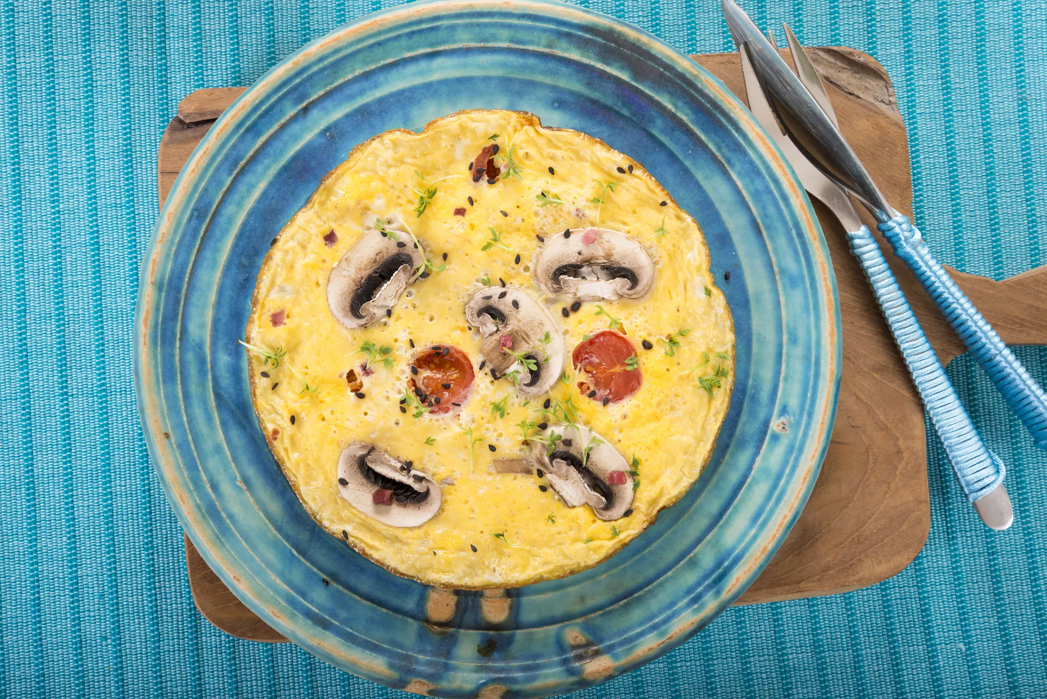 ham, mushroom, tomato omelette on blue plate