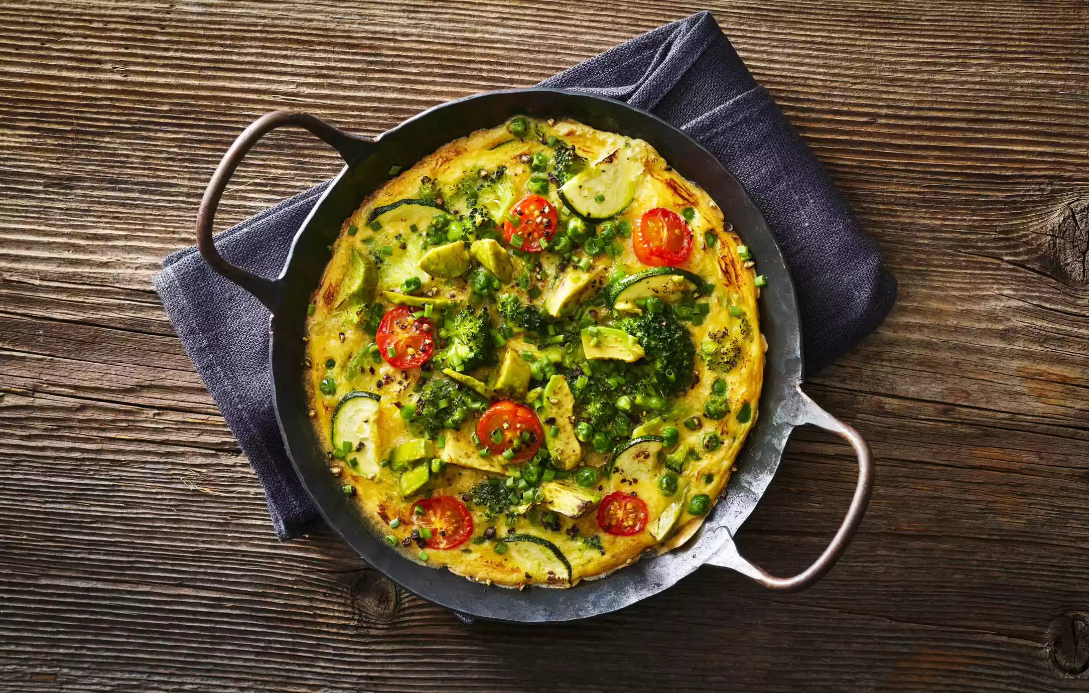 egg frittata with tomatoes, zucchini, and avocado