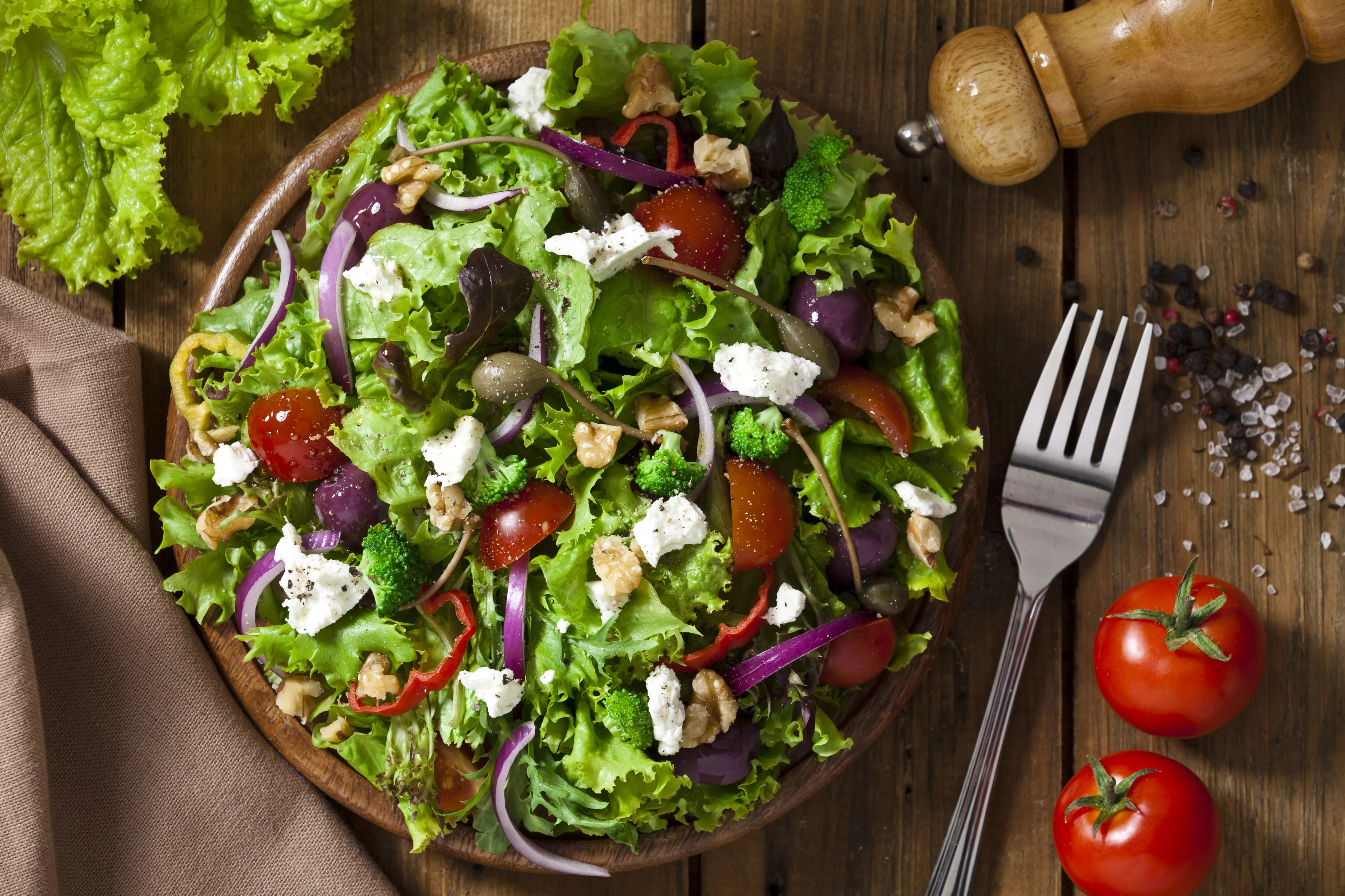 Spring salad shot from above on rustic wood table